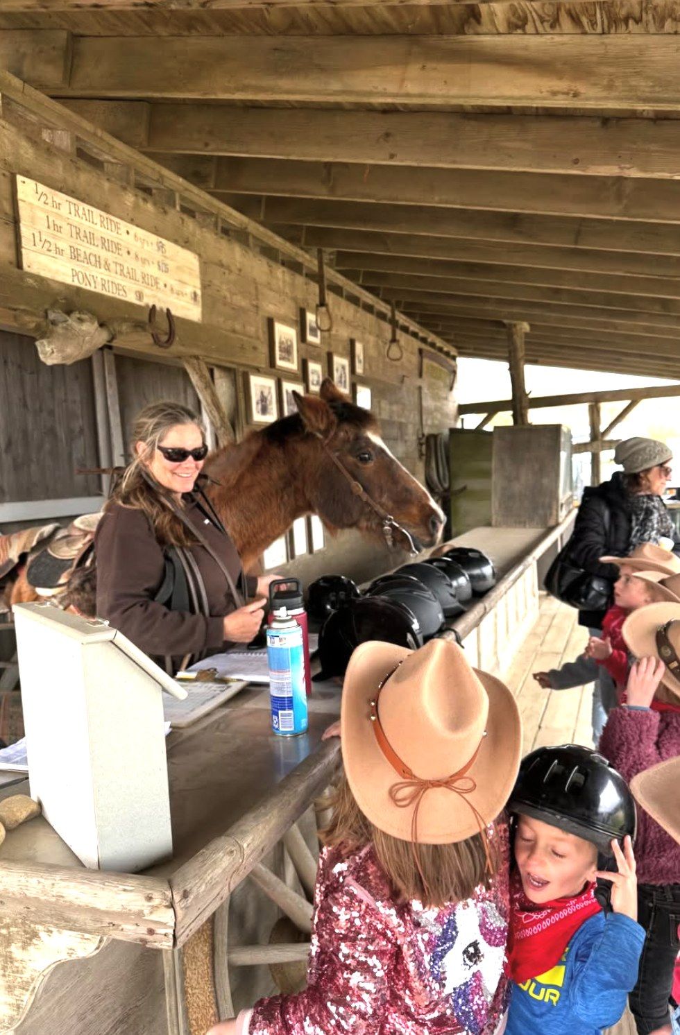 Children in cowboy hats at the check-in porch