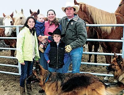 The Keogh family at the corral with their horses and dogs