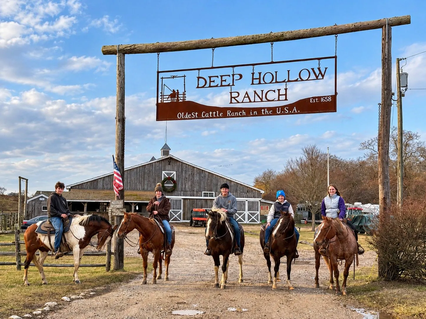 A group of riders under the Deep Hollow Ranch sign