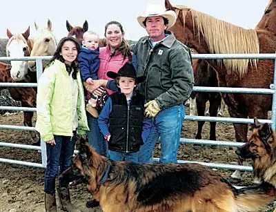 The Keogh family at the corral with their horses and dogs